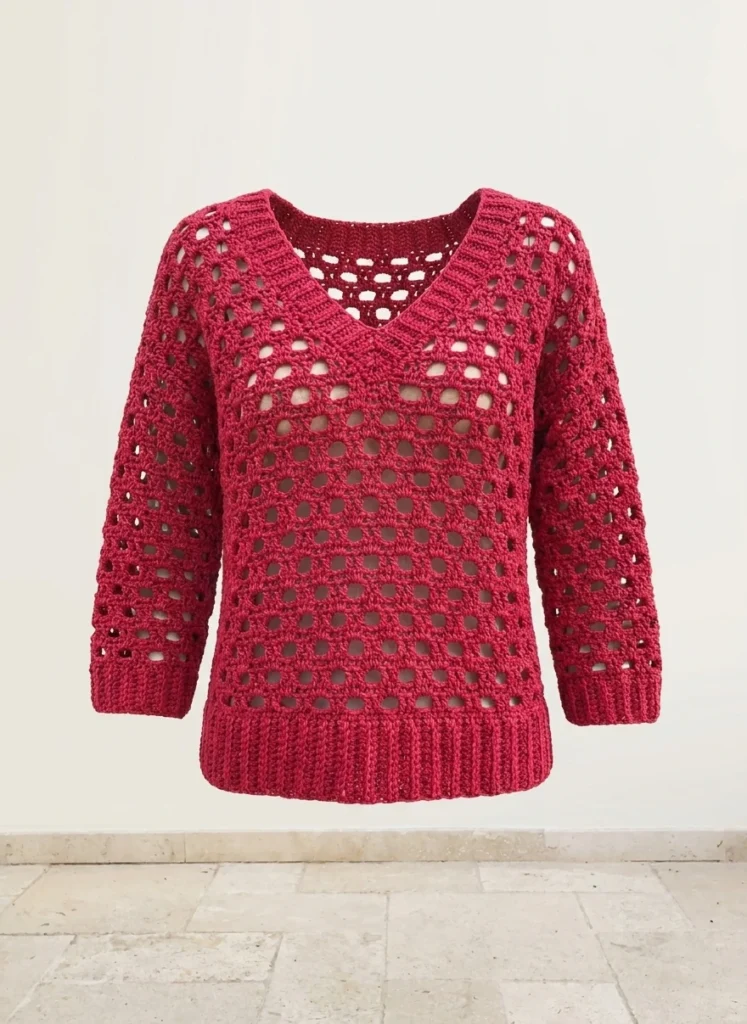 Red crochet openwork V-neck sweater with ribbed hem and three-quarter sleeves, displayed front-facing against a plain light background